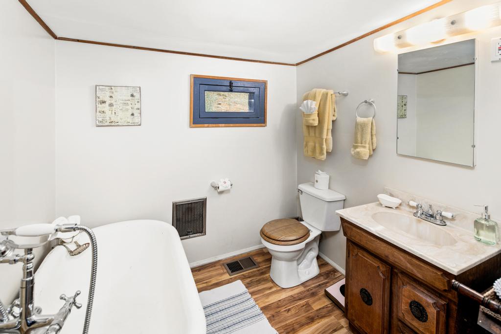 Bathroom with claw tub and separate shower.